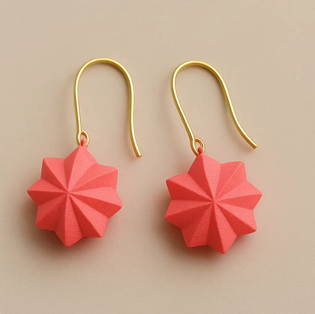 Fun geometric earrings in coral red with faceted starburst shape
