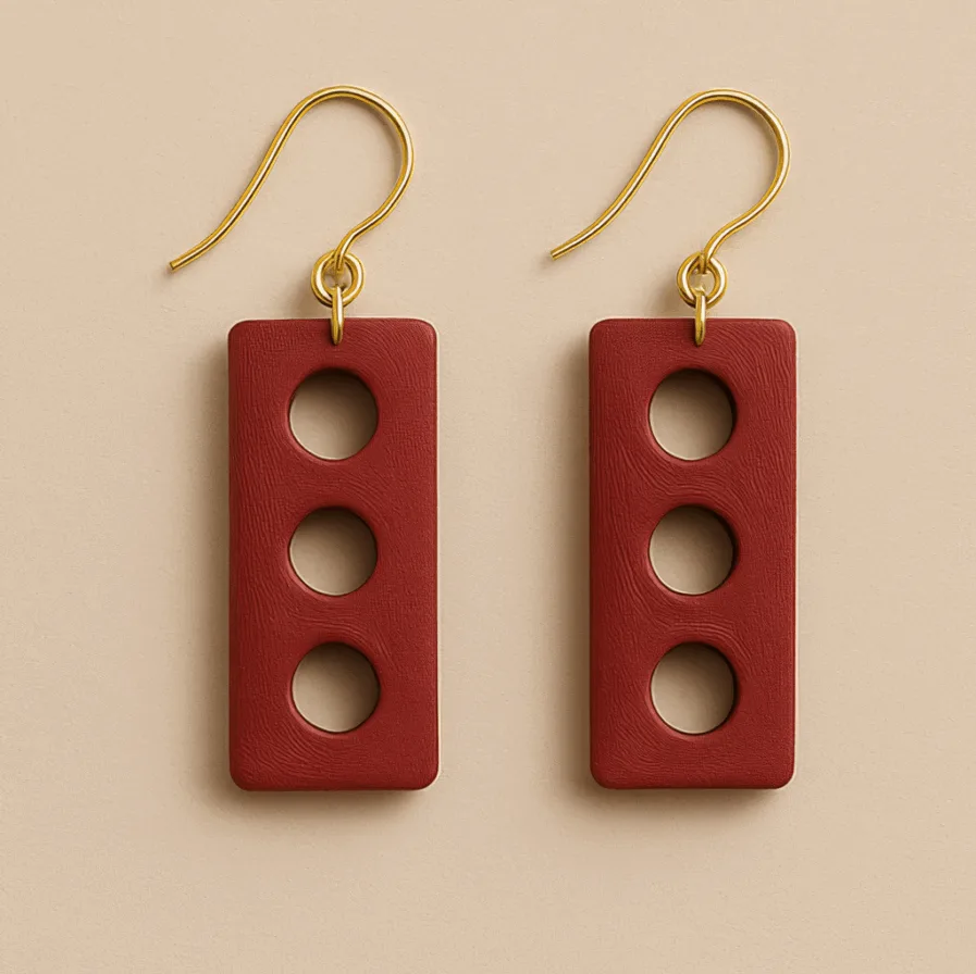 Fun geometric dangle earrings with three circular cutouts and gold hooks