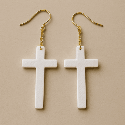 White cross dangle earrings with gold hook and lightweight matte finish