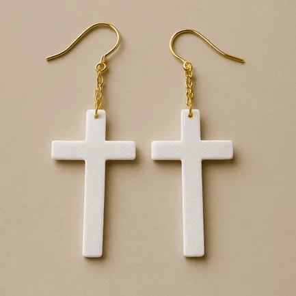 White cross dangle earrings with gold hook and lightweight matte finish