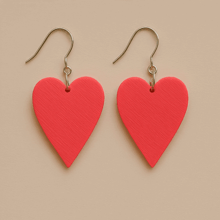 Red heart dangle earrings with matte surface and gold hooks