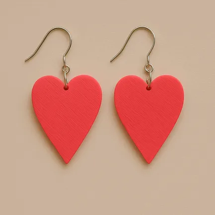 Red heart dangle earrings with matte surface and gold hooks