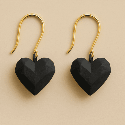 Black heart dangle earrings with faceted sculptural shape and gold hooks