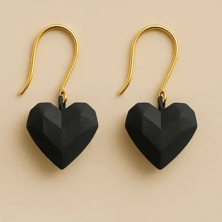 Black heart dangle earrings with faceted sculptural shape and gold hooks