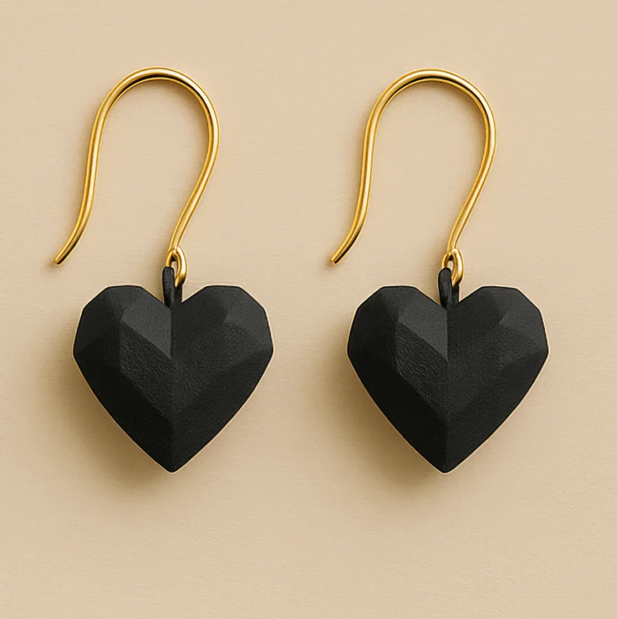 Black heart dangle earrings with faceted sculptural shape and gold hooks
